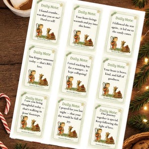 May include: A set of Daily Note cards featuring illustrations of a child and a camel. Each card has a different message, such as "I followed the star again... it led me to the candy canes." The cards are on a wooden surface.