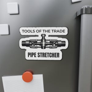 May include: A black and white magnet with the text "TOOLS OF THE TRADE" and "PIPE STRETCHER". The magnet features a detailed illustration of a pipe stretcher tool.