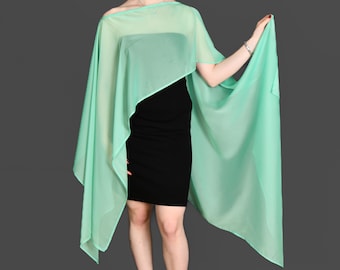 May include: A light green sheer shawl or wrap, draped over a person's shoulders. The shawl is made of a lightweight, flowing fabric.