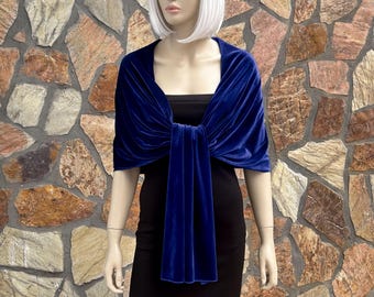May include: A royal blue velvet shawl with a long, flowing end that can be tied around the neck. The shawl is draped over a mannequin's shoulders and tied in the front.