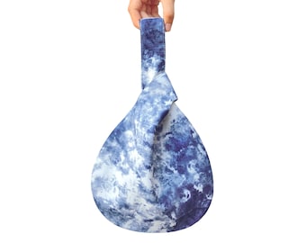 May include: A blue and white tie-dye fabric tote bag with a knotted handle.