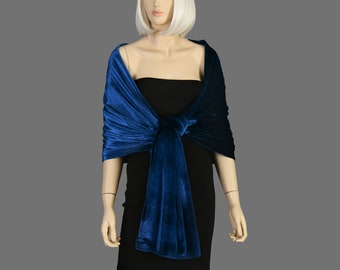 May include: A royal blue velvet shawl with a draped design. The shawl is tied at the front with a knot.