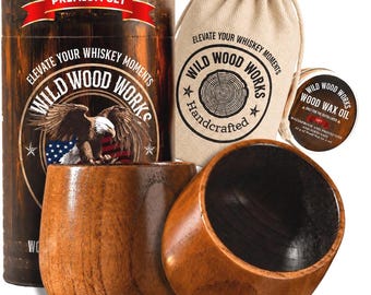 May include: A wooden whiskey set with two wooden cups, a canvas bag, and a wooden barrel-shaped container. The set includes a small container of wood wax oil. The barrel and bag have the text "Wild Wood Works".