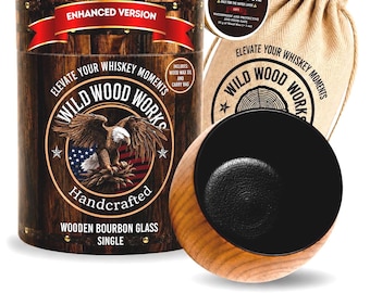 May include: A wooden bourbon glass set with a cylindrical container featuring an eagle emblem and the text "Wild Wood Works." Includes a wooden coaster with a black center, a canvas bag, and a small tin of wood wax oil.