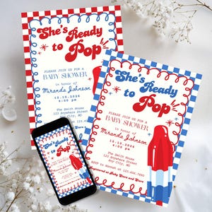 May include: Baby shower invitations with a red, white, and blue popsicle design. The invitations feature the text "She's Ready to Pop" in a playful font, along with event details. A smartphone displays the invitation.