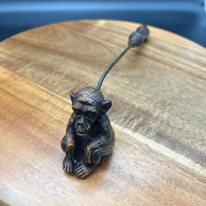 May include: A white ceramic mug with a black handle and the text "But First, Coffee" in a bold, black font. The mug is set against a blurred background, highlighting its clean design. The mug is approximately 4 inches tall.