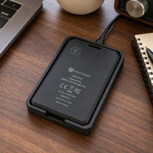 May include: A black rectangular MOKO SMART LW010-R device with a matte finish, featuring a power cable connected at the top. The surface displays technical text including MOKO SMART, LW010-R, Designed by MOKO Technology Ltd., CE, FC, FCC ID: 2A094-LW010, R68E7CE1, Input: 5V 0.5A, and Made in China.