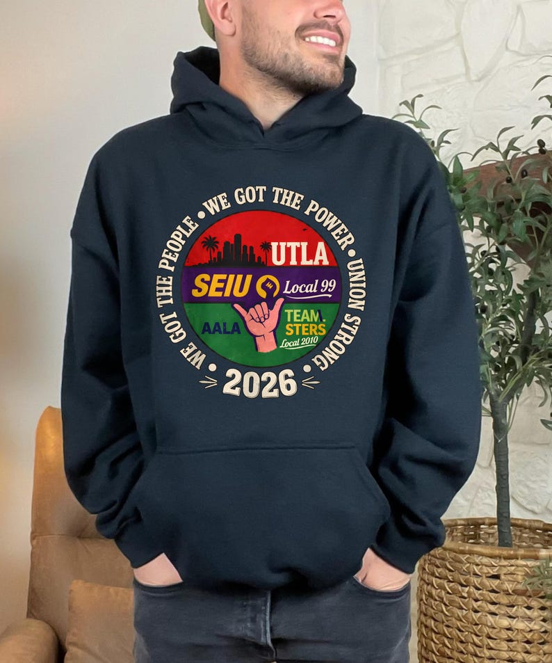 May include: Navy blue hooded sweatshirt with a circular graphic. The graphic includes the text "WE GOT THE PEOPLE" and "WE GOT THE POWER" around a central design with the text "UTLA", "SEIU Local 99", "TEAMSTERS Local 2010", and "2026".