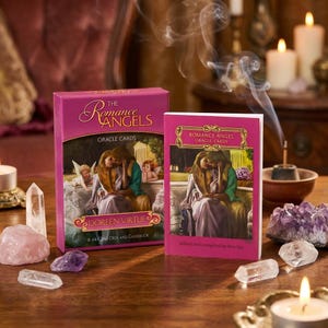 May include: A pink oracle card deck and guidebook titled "The Romance Angels" by Doreen Virtue. The box and guidebook feature an illustration of two figures embracing. Crystals and candles surround the deck.