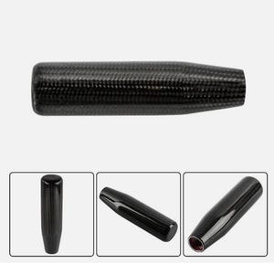 May include: A black carbon fiber gear shift knob with a textured surface. The image includes three additional views of the knob. The knob is cylindrical with a slightly tapered shape.