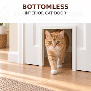 May include: A white bottomless interior cat door installed in a white door frame. The text at the top reads BOTTOMLESS INTERIOR CAT DOOR. An orange tabby cat is walking through the open rectangular frame, which is shown without a flap.