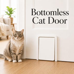 May include: A white rectangular cat door installed at the base of a white interior door. The text Bottomless Cat Door is printed in black above the door. A brown and grey tabby cat sits on the wooden floor next to the installed pet door.