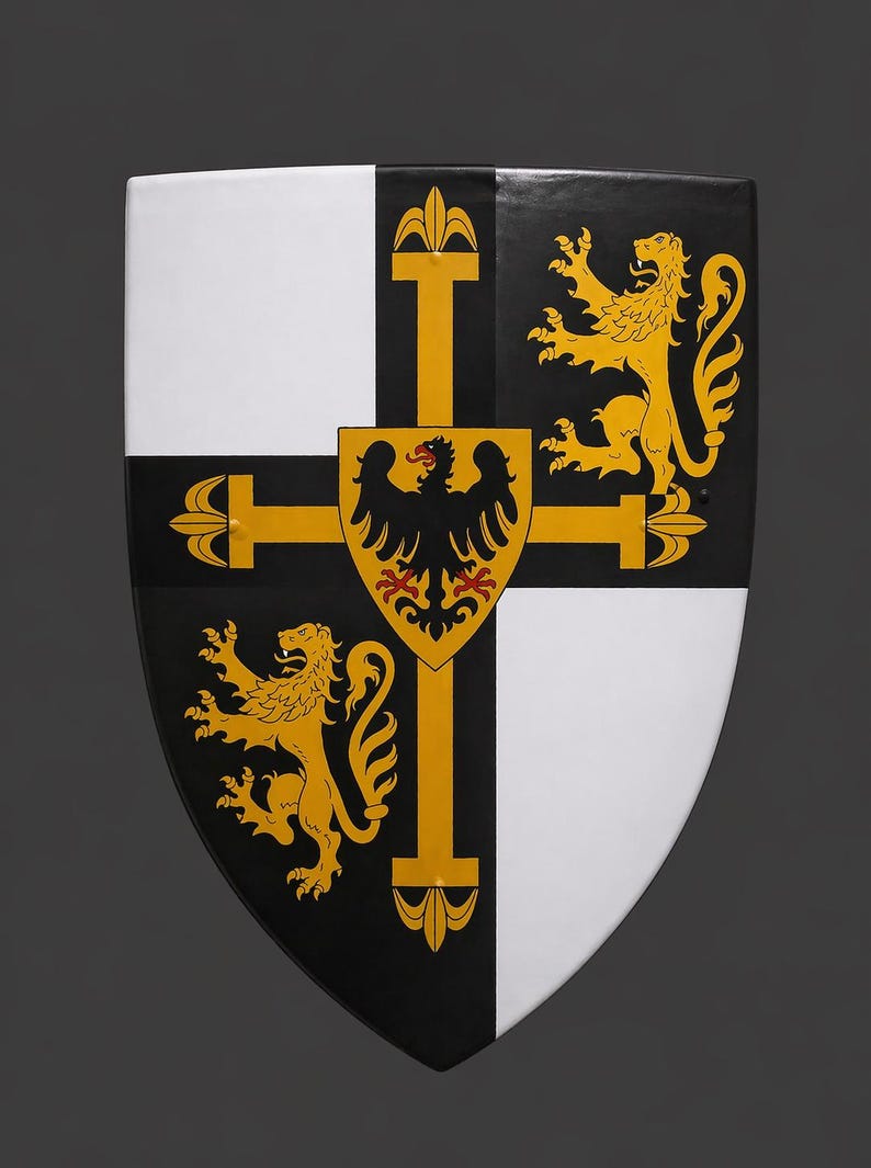May include: A medieval-style shield with a black, white, and gold design. The shield features a cross with a central emblem of a black eagle on a gold background. Two gold lions and two white sections complete the design.