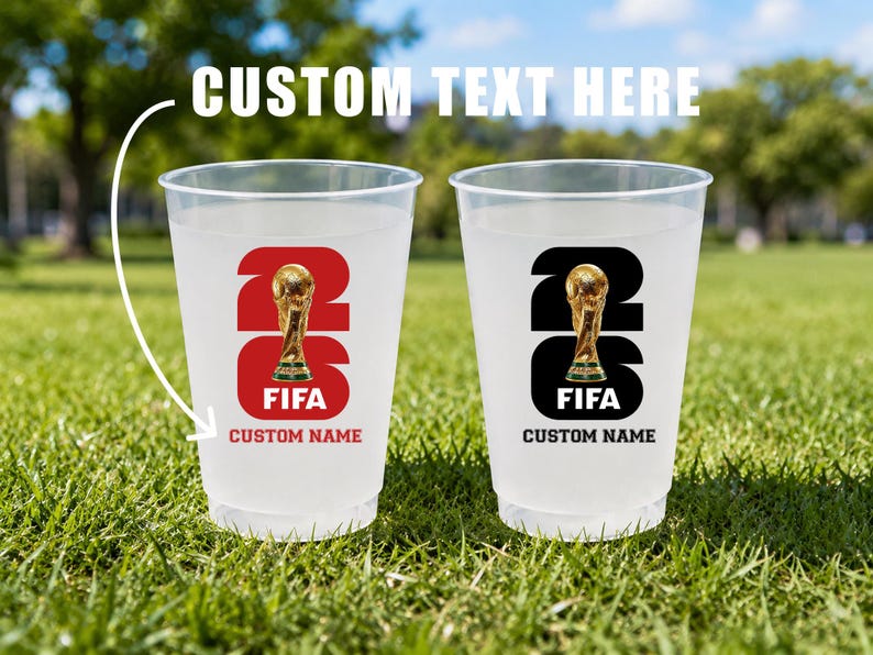 May include: Two clear plastic cups with a FIFA logo and the text "CUSTOM TEXT HERE". One cup has a red background, the other black. Both feature a gold trophy and space for a custom name.