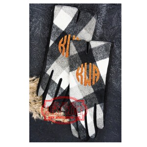 May include: Black and white check gloves with an orange glitter monogram. The gloves have a classic design with a black trim and are made of a soft, warm material. These gloves are ideal for cold weather.
