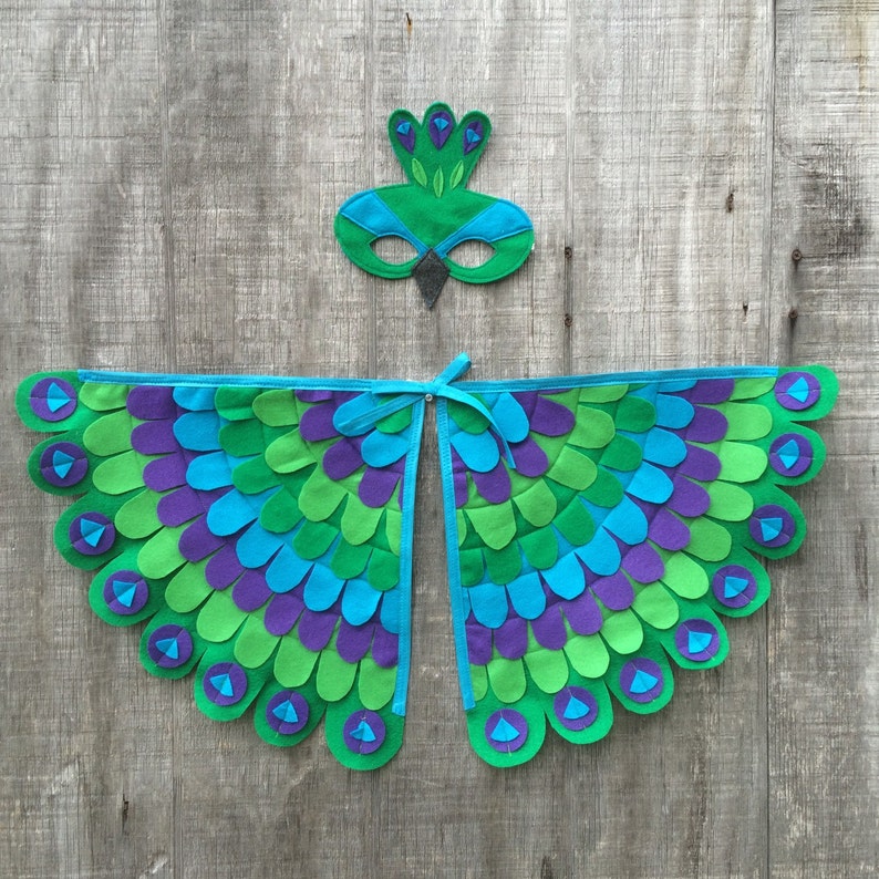 May include: A peacock costume for kids with green, blue, and purple felt wings and a matching eye mask.