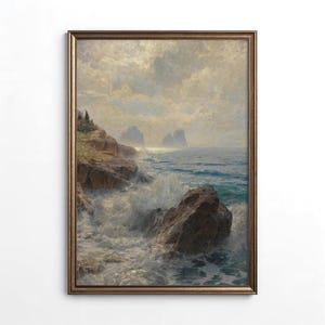 May include: A framed vintage landscape painting showing a coastal scene with waves crashing against rocks. The artwork uses a muted palette of blues, browns, and whites, with a cloudy sky and distant islands. The frame is a warm, golden brown.