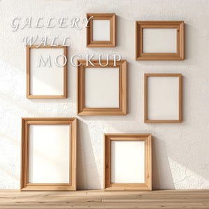 May include: A gallery wall mockup featuring seven wooden picture frames of varying sizes, arranged on a textured white wall. The frames have a natural wood finish and white matting. The text "GALLERY WALL MOCKUP" is displayed in a stylized font.