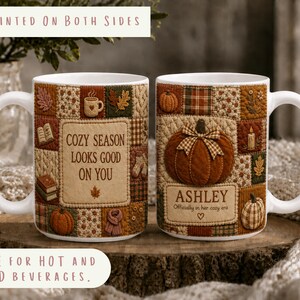 May include: Two white ceramic mugs featuring a patchwork quilt design in autumn colors. One mug displays the text COZY SEASON LOOKS GOOD ON YOU. The other mug features a large pumpkin illustration and the name ASHLEY with the text Officially in her cozy era.