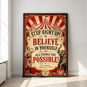 May include: A framed circus-themed poster with a red and cream striped tent background. It features a strongman in a striped leotard, an elephant, and the text: STEP RIGHT UP! TO BELIEVE IN YOURSELF AND ALL THINGS ARE POSSIBLE! - P.T. BARNUM -