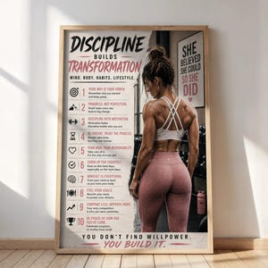 May include: A framed poster with the text "DISCIPLINE BUILDS TRANSFORMATION" and a list of motivational points. The image features a woman in workout attire, with the text "SHE BELIEVED SHE COULD SO SHE DID". The bottom reads "YOU DON'T FIND WILLPOWER. YOU BUILD IT."