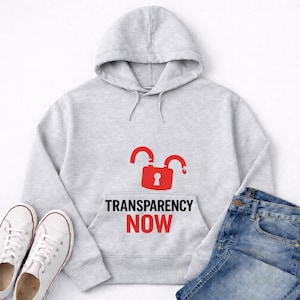 May include: A light gray hoodie with a red open padlock graphic and the words "TRANSPARENCY NOW" printed on the front. White canvas sneakers and blue jeans are also visible.