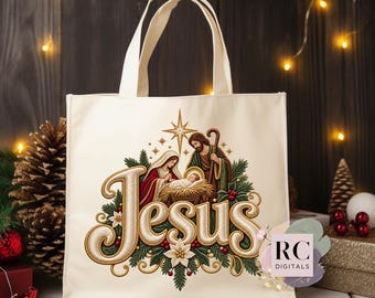 May include: A cream-colored canvas tote bag featuring a central embroidered design of the Nativity scene with the word Jesus in large gold lettering. The graphic includes Mary, Joseph, and the infant in a manger, surrounded by pine branches and berries.