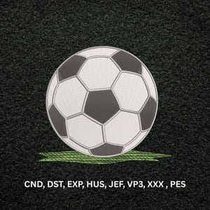 May include: An embroidered soccer ball design featuring white and dark gray hexagonal panels resting on a patch of green grass. The text CND, DST, EXP, HUS, JEF, VP3, XXX, PES is printed in white at the bottom of the dark textured background.