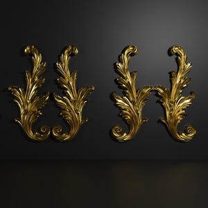 May include: Gold-colored decorative leaf ornaments. The image shows several ornate, gilded leaf designs, including symmetrical pairs and a longer, horizontal piece. These elements are set against a dark background, highlighting their intricate details.