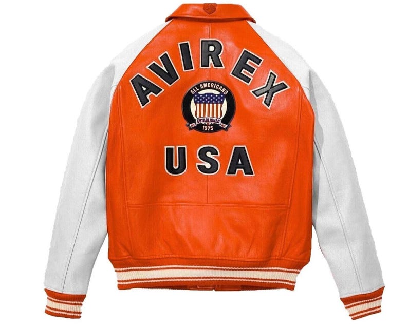 May include: Orange and white leather jacket with the word "AVIREX" across the back. The jacket has a patch with the words "ALL AMERICANS" and "USA" below it. The sleeves are white, and the cuffs and hem have striped detailing.