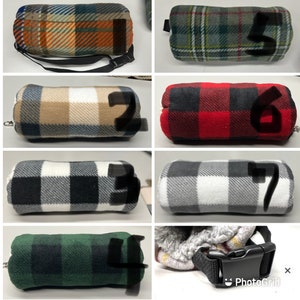 May include: Ten different plaid and patterned fleece neck warmers. The neck warmers are all in different colors and patterns, including red, green, blue, black, and white. Some of the neck warmers have a strap.