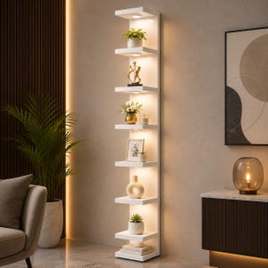 May include: A tall, white, vertical wall-mounted shelving unit featuring eight individual shelves. Each shelf is illuminated by a small, integrated circular light fixture. The shelves hold various decorative items, including potted plants, a gold sculpture, a picture frame, and a ceramic vase.