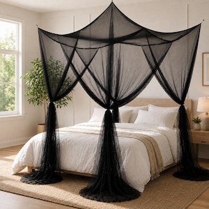 May include: A black four-poster bed canopy made of sheer, fine-mesh netting. The canopy features a square top frame that suspends the fabric, which drapes down to the floor at each corner, creating a structured, semi-transparent enclosure.