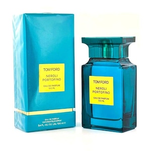 May include: A turquoise perfume bottle and matching box. The bottle and box both feature the text "TOM FORD NEROLI PORTOFINO EAU DE PARFUM 100 ML". The bottle is a square shape with a turquoise cap and contains a blue liquid. The box reads "EAU DE PARFUM VAPORISATEUR SPRAY 3.4 FL. OZ./OZ. LIQ./100 ml e".