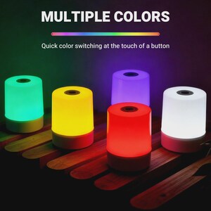 May include: A display of six color-changing LED lamps. The lamps are cylindrical with a circular opening on top and a contrasting base. The text "MULTIPLE COLORS" and "Quick color switching at the touch of a button" are visible.