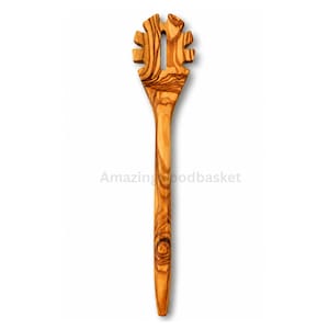 May include: A wooden spaghetti server with a slotted head and long handle. The server is made of olive wood, featuring a natural wood grain pattern. The text "Amazing Woodbasket" is visible on the image.
