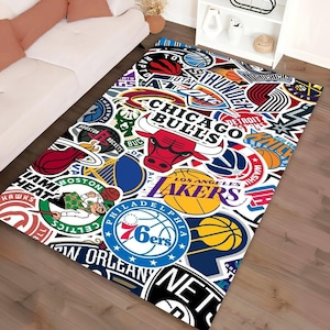 Puede incluir: Alfombra rectangular con un collage de logotipos de equipos de la NBA. La alfombra muestra logotipos de los Chicago Bulls, Los Angeles Lakers, Boston Celtics y otros equipos. El diseño es una mezcla de rojo, blanco, azul y amarillo.