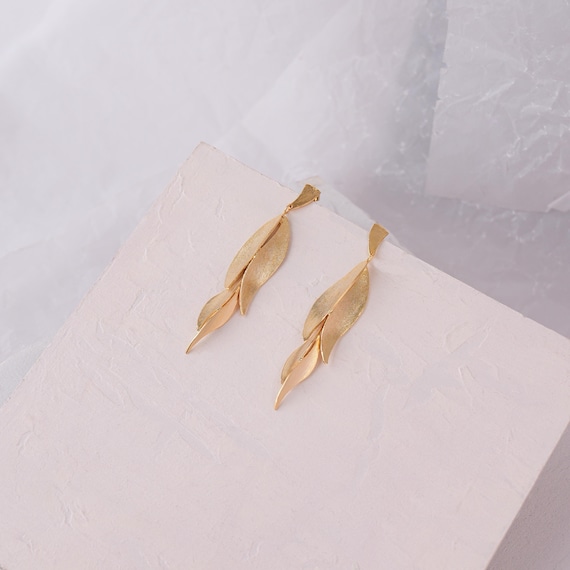 Statement leaf-like Gold stud earrings, also available in Silver and Gold with Black
