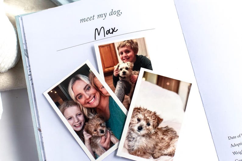 May include: Open book with the text "meet my dog, Max" and several photos of a dog with people. The photos are of a small, fluffy, brown and white dog with people.