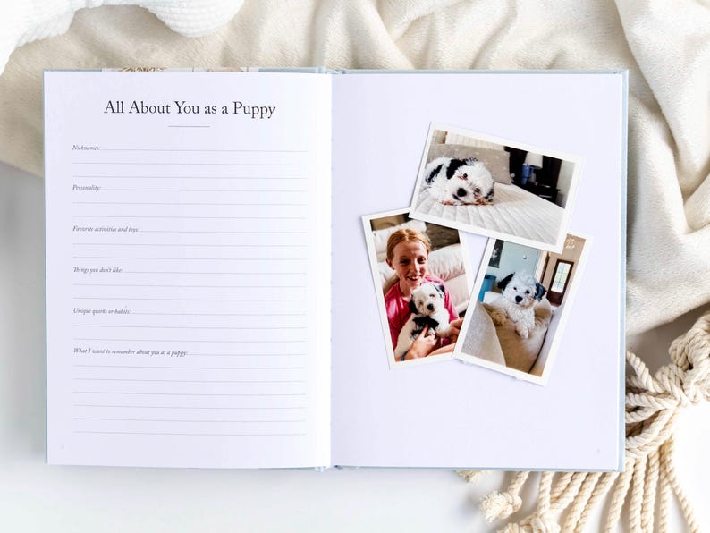 May include: Open notebook with the text "All About You as a Puppy" and lined pages. Three photos of a puppy are on the right page. The puppy is black and white. The notebook is on a white surface.