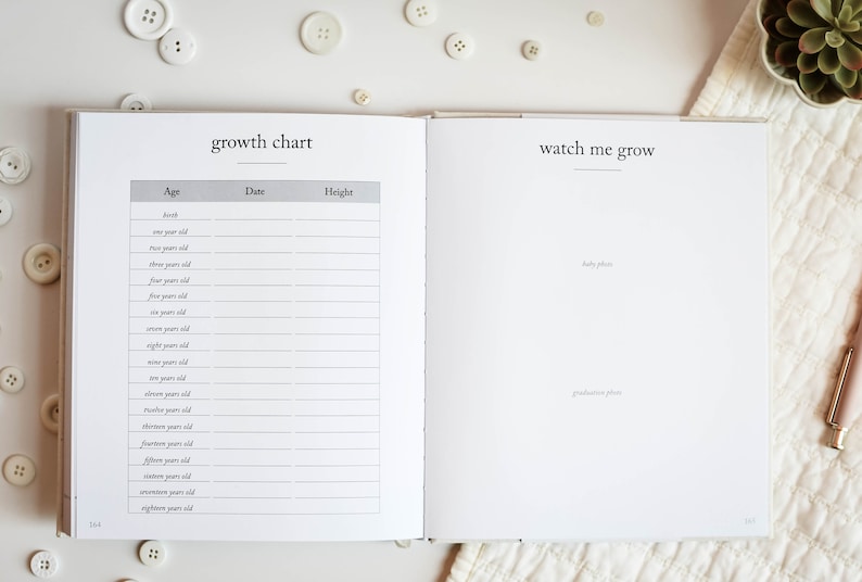May include: A white baby book with a growth chart on the left page and a "watch me grow" section on the right page. The growth chart has columns for age, date, and height. The right page has space for baby photos and graduation photos.