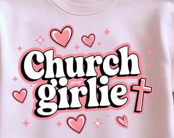 May include: Pink sweatshirt with the text "church girlie" in white with a black outline. The text is in a retro font style. There are pink hearts and stars scattered around the text. A pink cross is to the right of the text.