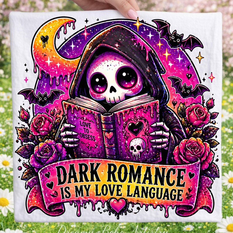 May include: White graphic tee featuring a cartoon skull in a black hooded robe reading a book with the words "Love to Obsess". The design includes bats, roses, and the text "Dark Romance Is My Love Language".