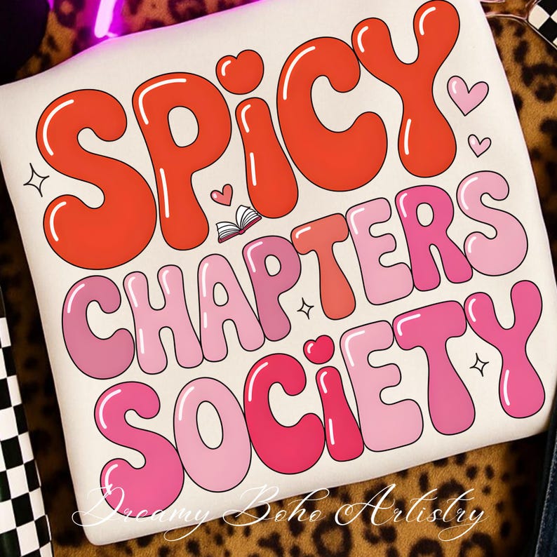 May include: Cream cushion featuring the text "SPICY CHAPTERS SOCIETY" in bubble letters. The words are in shades of red and pink, with heart and star motifs. The design has a retro, groovy style, reminiscent of the 1970s.