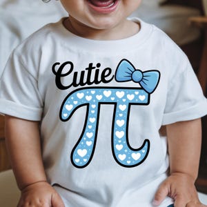 May include: White t-shirt with the word "Cutie" in black script and a light blue bow. The shirt features a light blue pi symbol filled with white hearts. The shirt is for a baby or toddler.