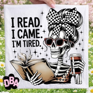 May include: White decorative towel with a skeleton graphic wearing sunglasses and a checkered bow, holding a book and a coffee cup. The text reads "I READ. I CAME. I'M TIRED."