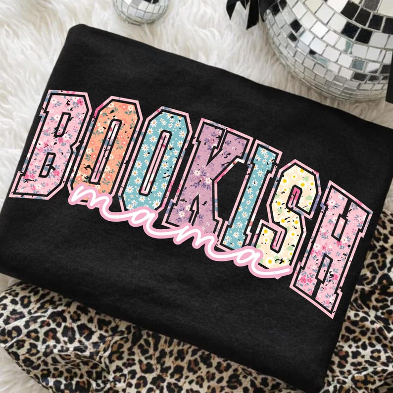May include: Black sweatshirt with the text "BOOKISH mama" in a colorful floral design. The letters are outlined in pink and the floral patterns include pink, blue, yellow, and orange.