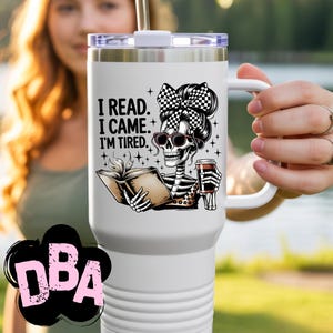 May include: White travel mug with a black and white skeleton graphic wearing sunglasses and a checkered bow. The skeleton is holding a book and a coffee cup. Text on the mug reads: "I READ. I CAME. I'M TIRED."