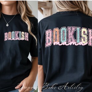 May include: Black t-shirt with the word "BOOKISH" in a floral design across the front. The back of the shirt features the words "BOOKISH mama" in a similar floral design. The shirt is a casual, comfortable style.