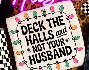 May include: Off-white sweatshirt with the phrase "DECK THE HALLS and NOT YOUR HUSBAND" in black. The text is framed by a string of colorful Christmas lights. The sweatshirt has a festive holiday theme.